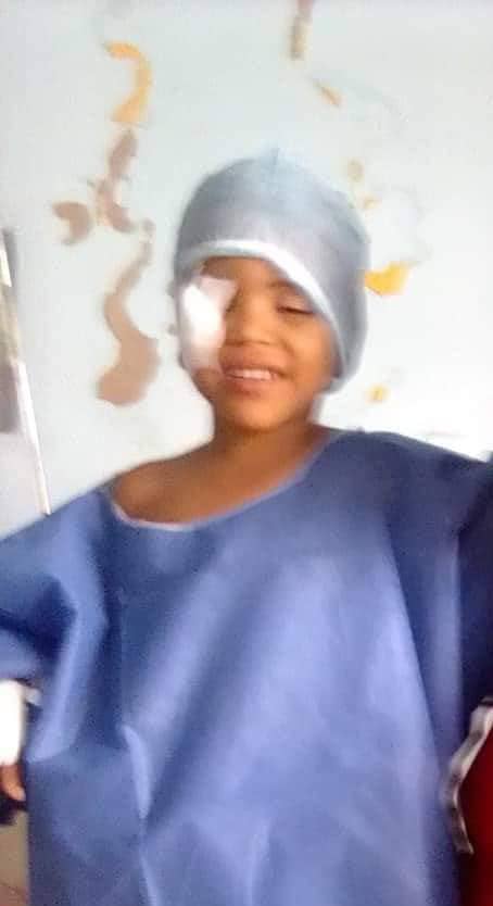 A child smiling after a successful eye operation