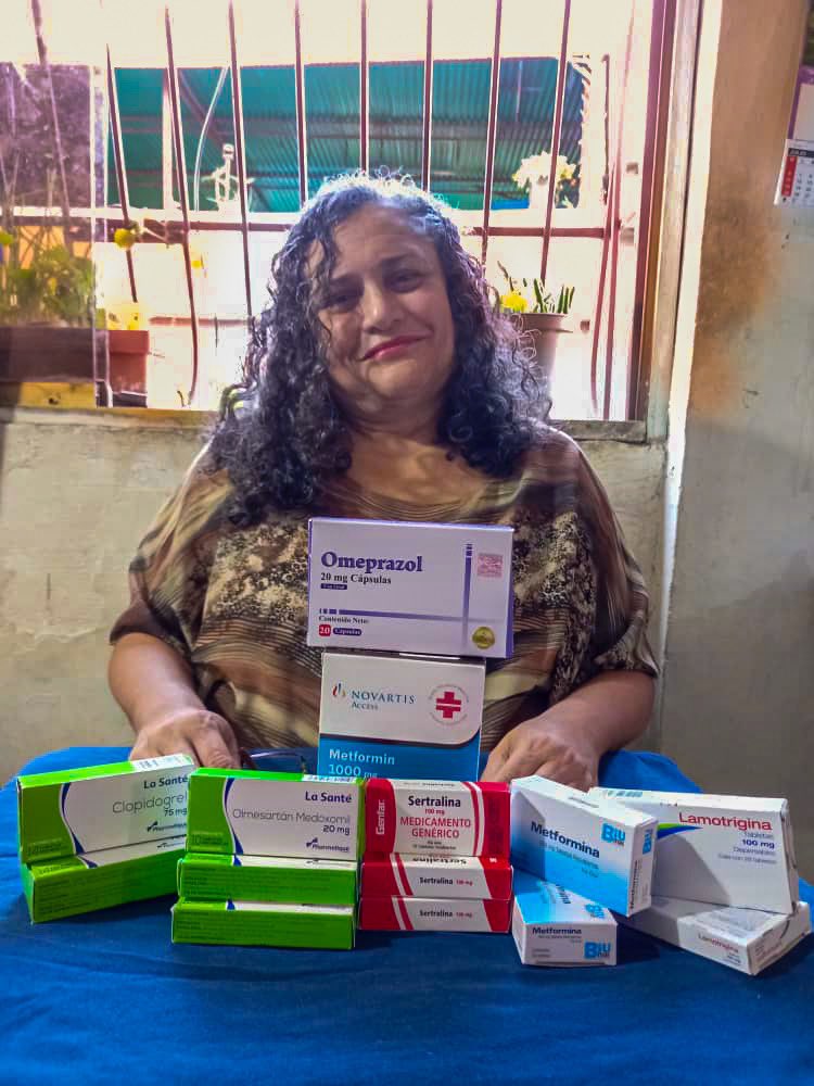 A woman with the medication her campaign helped her buy