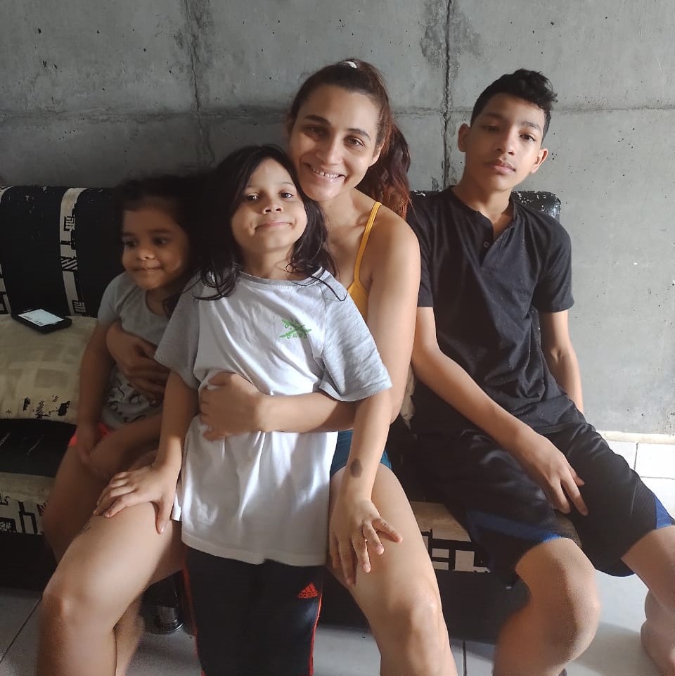 A mother sitting with her three children